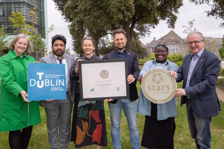 6 people standing outside holding awards and signs for a STARS award