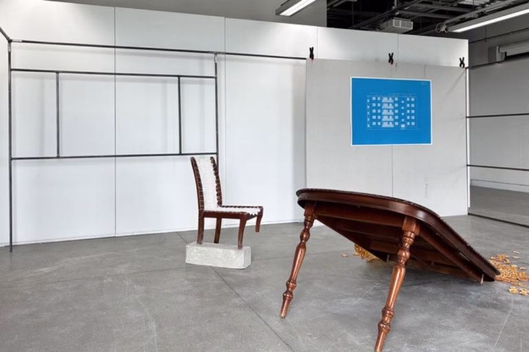 An art installation featuring a wooden chair and table